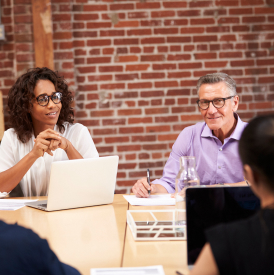 businesswoman-leading-office-meeting-of-colleagues